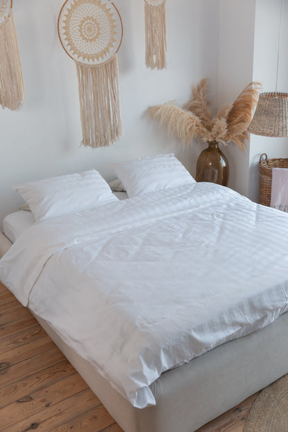 ARTELI white cotton bedding set on bed - premium hotel quality sheets
